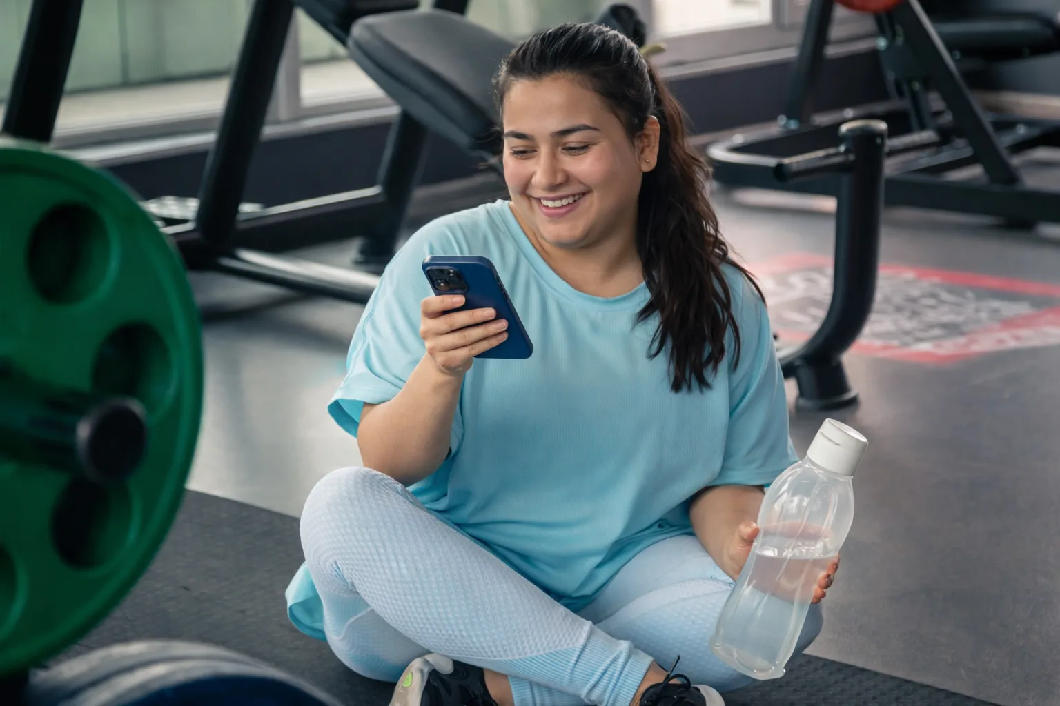 Certified personal trainer reviewing client progress and workout plans